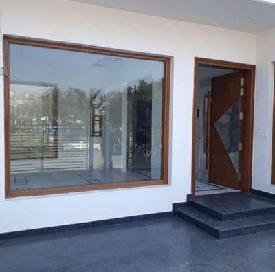 fixed toughned glass frame #glassworks #fixedglass #fixedwindow #aluminiumframing #woodenfinish #toughnedglasswork #Architectural&Interior #exteriordesigns #modernhome #WindowsIdeas #daylighting #clearglass #intsignhomeinteriors