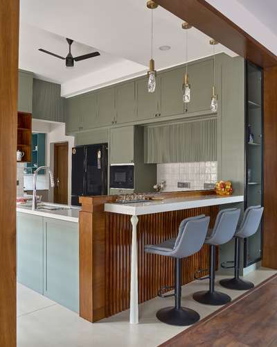 Earthy Elegance Meets Modern Functionality
A fully customised kitchen designed to balance beauty and practicality.
Featuring semi-glossy PU-finished cabinets in a custom shade, premium quartz countertops, and a sleek breakfast counter highlighted with crystal pendant lights.

The extended crockery shelf blends seamlessly with the wall cabinetry, while the open layout ensures natural light and clutter-free spaciousness.
Rich teakwood finishes add warmth, blending earthy, modern colonial, and contemporary styles into a timeless, raw yet refined aesthetic.

A space crafted with purpose, comfort, and individuality.  #KitchenInterior #interiordesign  #moderncolonialdesign #conteporaryhouse #custominterior #functionalluxury #openplankitchen #opendesign #teakwood #pupolish