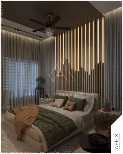 A serene contemporary bedroom defined by layered textures and a calm, earthy palette. The upholstered low-height bed in soft beige is styled with muted green and sand-toned linens, creating a relaxed, inviting focal point. Behind it, a vertical slatted feature wall integrated with warm linear lighting adds rhythm, depth, and a subtle sense of luxury without overpowering the space #Architect  #architecturedesigns  #Architectural&Interior  #Architectural&nterior  #keralarchitecturetecture  #archi_hunter  #best_architect