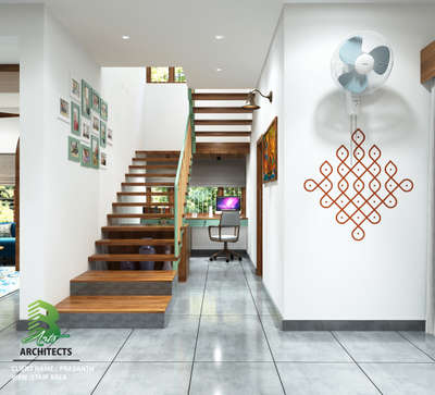 Modern home stairwell with wooden steps, white walls adorned by framed photos and a red Kolam design. Upstairs: a mint-green desk with computer under gray blinds; wall-mounted fan above. 

client :  Prasanth. 
Area. :   Stair Area