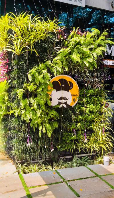 live green wall with logo #tropical roots landscaping #client-chef martins,kottayam,kerala