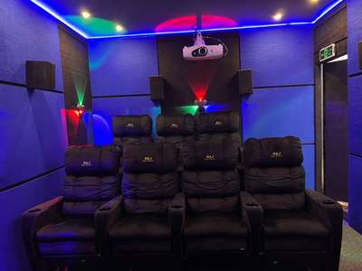 The home cinema is designed with state-of-the-art audiovisual technology, providing an immersive viewing experience. Comfortable, plush seating and optimized acoustics ensure that every movie or show is enjoyed to the fullest. #architecturedesigns  #Architectural&Interior  #InteriorDesigner  #KeralaStyleHouse #ContemporaryHouse #HouseDesigns