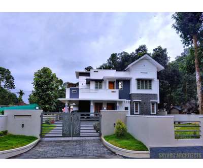A Fusion Model House Constructed at Thodupuzha 
• 4 Bed Room with attached Bathroom, Drawing, Dinning+living , Kitchen + Work Area 
🌟 Area : 2058 sqft