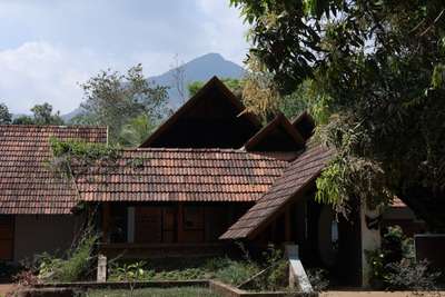 "മൽഹാർ "
Mountains in the background were the major inspiration for the level play happening on roofs. The house's high, steeply sloping roof, which has eaves for shade and to ward off a violent rainstorm, was laid with recycled tiles.

#archdaily #veeduvanitha #veedumplanum #TraditionalHouse #budgethomez #designkeralaresidence #designkerala #sustainableconstruction #ElevationHome #HouseDesigns #veeduvanitha