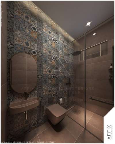 This modern toilet features a striking patterned tile accent wall that adds color and texture to the space. Architectural details include a sleek recessed ceiling with soft cove lighting and integrated spotlights. A glass partition separates the shower area, while a wall-mounted sink and toilet keep the floor clear. These features create a clean, high-end look that feels organized and very stylish. #Architect  #architecturedesigns  #Architectural&Interior  #architectsinkerala  #kerala_architecture  #best_architect