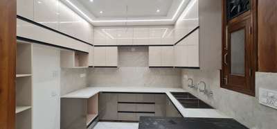an open kitchen with simpolo quartz stone, laminate beautifully design by aayam consultants