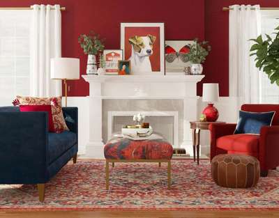 Get this classic maroon living room with : Blue and maroon sofa, printed cushion low coffee table, and a printed maroon rug. Add Curtains, lamp shades and table decors in shades of white to balance the colour pallette. #interior #decor #ideas #home #interiordesign #indian #colourful #decorshopping