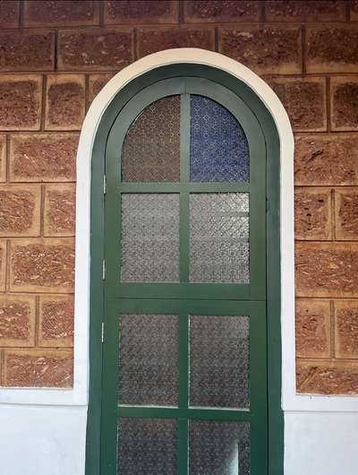 Arch window on exposed laterite wall