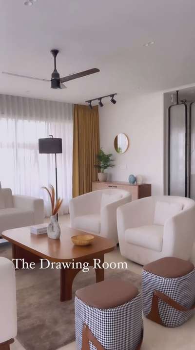 A modern, spacious living room with soft neutral tones. The space features a large L-shaped sofa  with pattern  throw pillows, two cozy armchairs, and a sleek wooden coffee table. The soft lighting and minimalist decor create a inviting atmosphere, perfect for relaxation

contact for consultancy 
@peculiar_design_studio ( Instagram) 

 #Minimalistic #LivingroomDesigns #Best_designers #best_architect #LUXURY_INTERIOR #LUXURY_SOFA #luvingroomplans