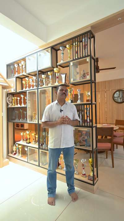 Behold the pride and joy of Mr. Shabu's Residence - our bespoke partition showcase! Seamlessly dividing the living room and dining hall, this elegant showcase is more than just a divider; it's a tribute to the remarkable achievements of the Shabu family. Adorned with trophies and accolades, each shelf tells a story of dedication, perseverance, and triumph. Step closer and witness the legacy of success, beautifully displayed for all to admire.  #AchievementShowcase #FamilyPride #LegacyOfSuccess #KoloApp #NDecor