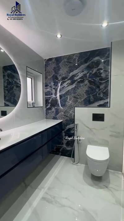 Luxury Bathroom with wall mounted toilet and Glass partition.Royal Builders Trivandrum