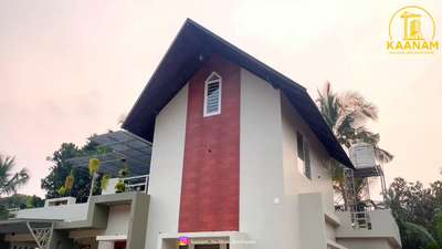 ✨ A Dream Home Among Nature | KAANAM BUILDERS AND DEVELOPERS ✨

We are proud to unveil another stunning two-storey residence in the northernmost beauty of Kerala — Kasaragod ❤️

Located near the scenic Karichery viewpoint, surrounded by hairpin bends, flowing Karichery river, and connected through the Perladukkam – Pandikandam road, this home is a true architectural gem built to impress.

(1800 sq.ft)
🏡 Home Features – Ground Floor
1️⃣ 2 spacious bedrooms with bay windows & a dedicated study area
2️⃣ Stylish living space with Verity pooja room & elegant TV area
3️⃣ Open kitchen + dining hall with a stunning wooden staircase that wraps around the dining area
4️⃣ Store area for practical storage
5️⃣ Work area for convenience
6️⃣ 2 modern toilets

🌿 First Floor Highlights
• A green luxury-style balcony — resort vibes especially in the evenings & nights ✨
• A versatile open room designed to convert into a home gym or mini theater in the future 🎬💪

✨ Design & Experience