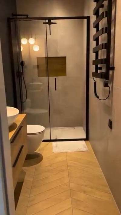 ചെറിയ bathroom ആയാലും design perfect ആണെങ്കിൽ അതിന്റെ charm വേറെ level!
👉 Beige wooden flooring + grey wall tiles = classy combo
👉 Wall-hung closet + beige vanity with white basin & black tap
👉 Round mirror + 4 white hanging lights = ambience super 👌
👉 Black shower set + towel rack + glass partition finish

💡 Small space → stylish presentation → premium feel guaranteed!

👉 നിങ്ങളുടെ bathroom-നും ഇങ്ങനെ ഒരു modern look വേണമോ?
📩 DM ചെയ്യൂ, ഞങ്ങൾ help ചെയ്യും 👍
#BathroomGoals #BlueNorthStyle #KeralaInteriors #HomeTrends2025 #LuxurySanitaryware #BathroomInspo #ElegantInteriors #LuxuryHomeDesign #KeralaBathroom #ModernBathroomDesign