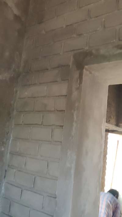 Exposed brick waterproofing on bathroom wall