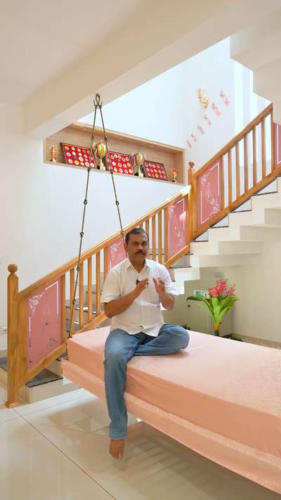 Preserving heritage while maximizing space - discover the soulful touch beneath the staircase at Mr. Shabu's Residence. Our cherished ancestral wooden swing, adorned with brass chains, finds a new home in this cozy alcove. It's more than just a swing; it's a piece of family history, inviting moments of reflection and relaxation. Embrace tradition, reclaim space, and cherish every swing as a connection to generations past.  #AncestralTreasure #SpaceOptimization #FamilyLegacy #KoloApp #NDecor